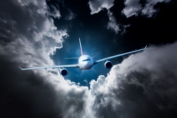 <p>Caption: Passenger Airliner flying in the clouds</p>